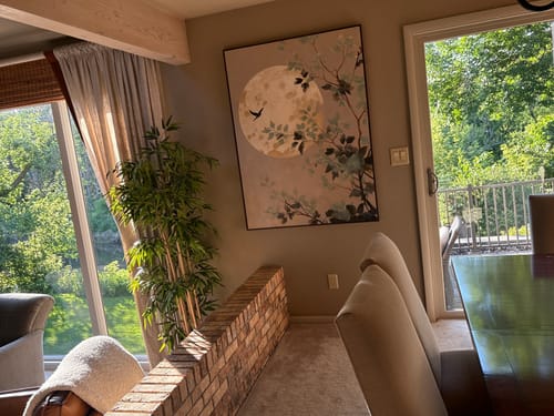 Reviewer's large art print showing a full moon and tree branches hanging in their home.