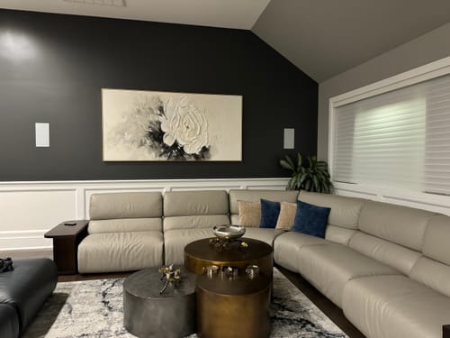 Customer's textured Creamy Petal Whisper painting displayed on a dark accent wall in their living room.